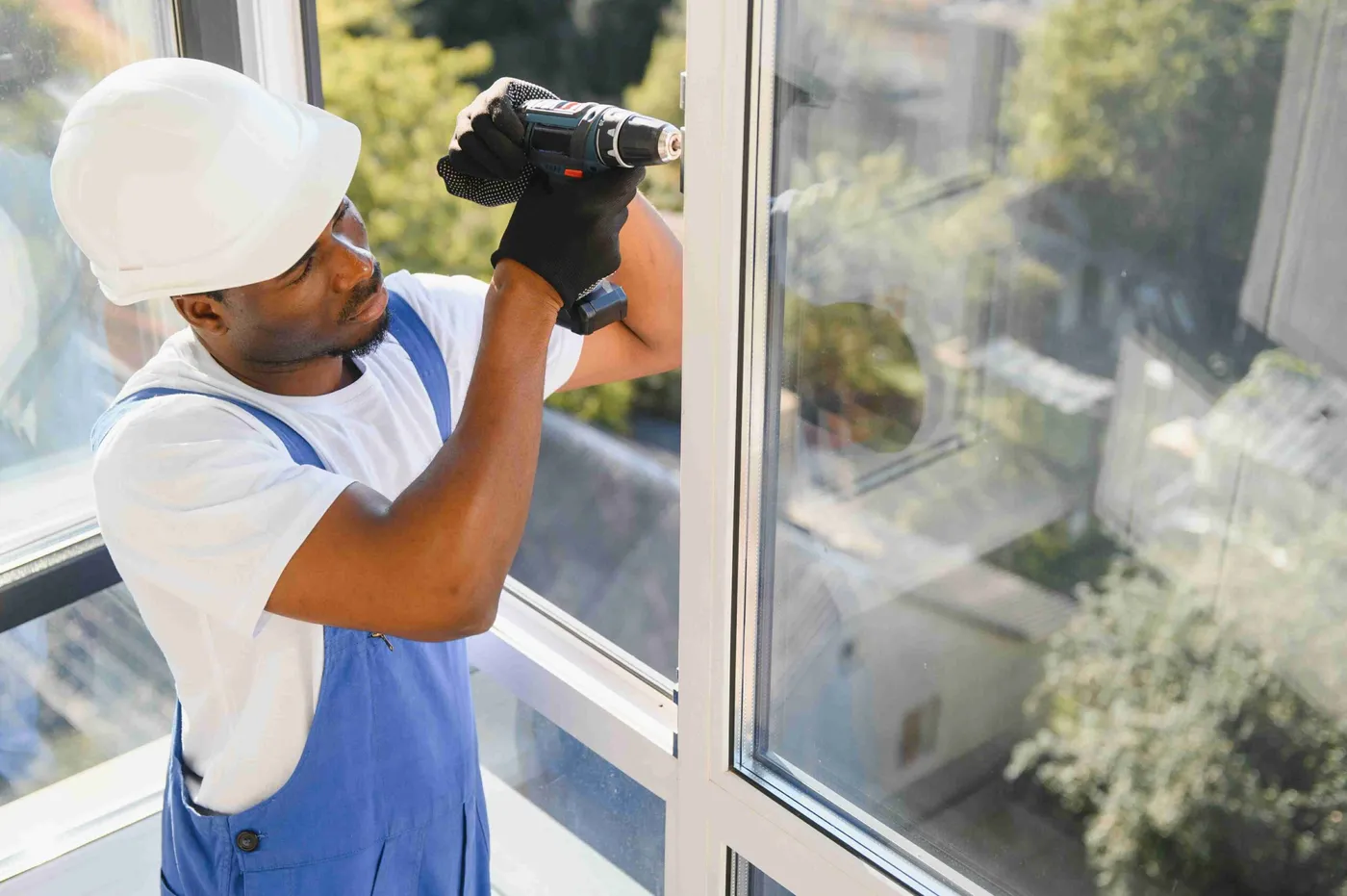 A VizioGlazz installer fitting a glass window